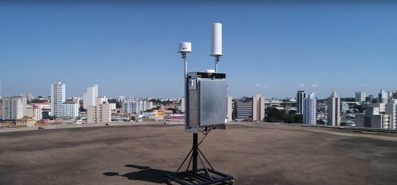 Unidade remota de medição CellWireless instalada na cobertura de um prédio, com antenas e vista da cidade